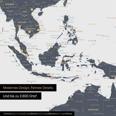 Détail d'une carte du monde magnétique en bleu denim montrant la carte de l'Asie, où des aimants marquent des destinations de voyage
