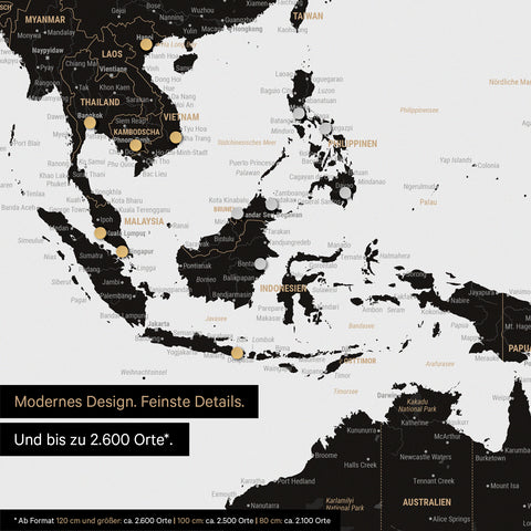 Extrait d'une carte du monde magnétique en noir clair (blanc noir) montrant la carte de l'Asie, sur laquelle des aimants marquent des destinations de voyage