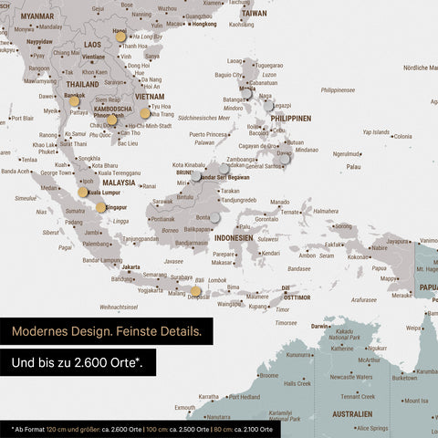 Détail d'une carte du monde magnétique multicolore Light montrant la carte de l'Asie, où des aimants marquent des destinations de voyage