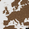 A detailed section of a brown world map pinboard shows a section of Europe with all countries and capitals.