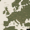 A detailed section of an olive green world map pinboard shows a portion of Europe with all countries and capitals.