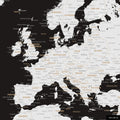 A detailed section of a black and white world map pinboard shows a portion of Europe with all countries and capitals.